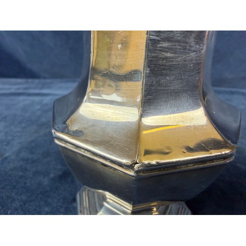 100 - A silver sugar shaker of plain design and pierced top, hallmarked London 1933-1934, makers mark J. W... 