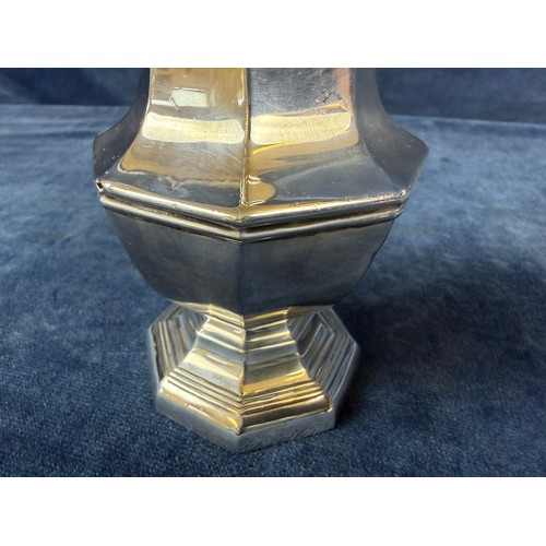 100 - A silver sugar shaker of plain design and pierced top, hallmarked London 1933-1934, makers mark J. W... 