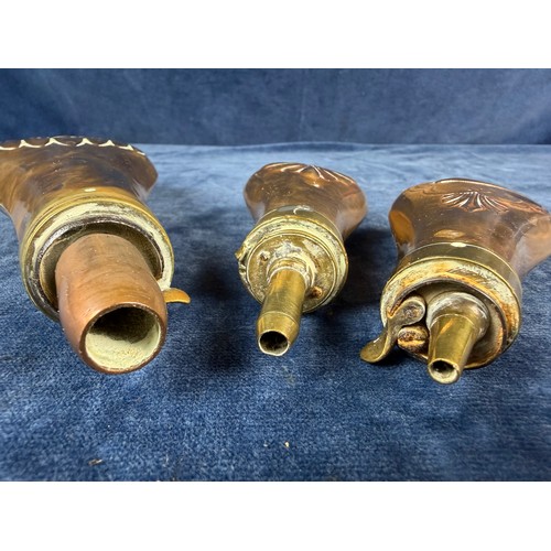 320 - Three antique copper and brass gunpowder flasks.