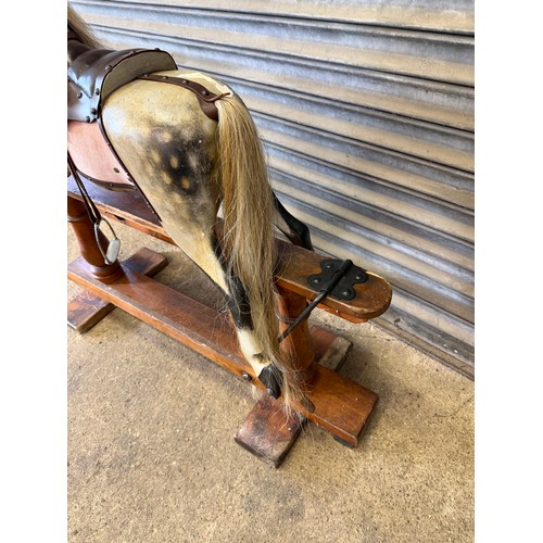 19 - An antique rocking horse with dapple grey colouring and horse hair mane and tail on pitched pine bas... 