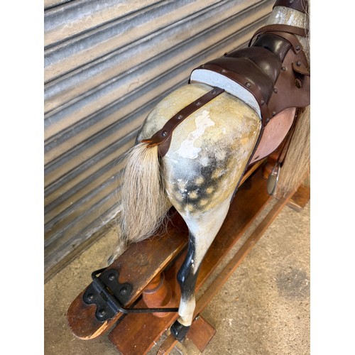 19 - An antique rocking horse with dapple grey colouring and horse hair mane and tail on pitched pine bas... 