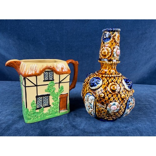 211 - A W. H. Goss pottery jug in the design of a cottage together with an alrambrian vase, with brown and... 
