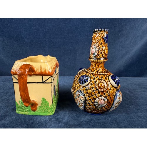 211 - A W. H. Goss pottery jug in the design of a cottage together with an alrambrian vase, with brown and... 