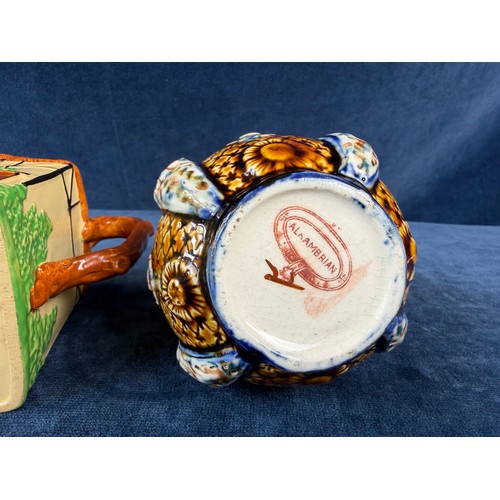 211 - A W. H. Goss pottery jug in the design of a cottage together with an alrambrian vase, with brown and... 