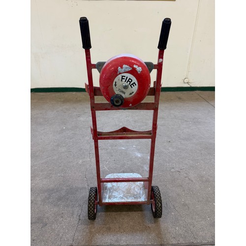 16 - A vintage set of sack wheels with a mounted fire bell on reverse.