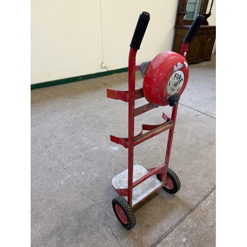 16 - A vintage set of sack wheels with a mounted fire bell on reverse.