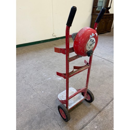 16 - A vintage set of sack wheels with a mounted fire bell on reverse.