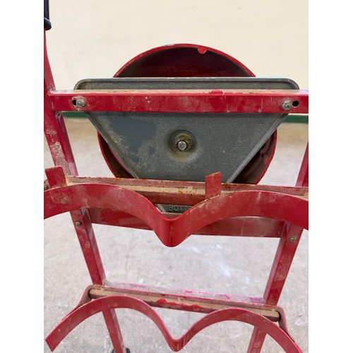 16 - A vintage set of sack wheels with a mounted fire bell on reverse.