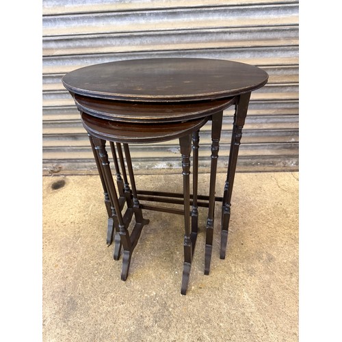 462 - An antique nest of 3 tables on shaped legs.