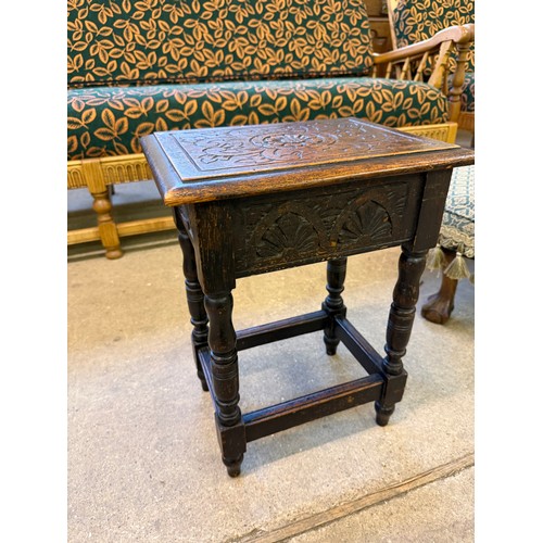 470 - A small carved oak stool/ side table with hinged top.