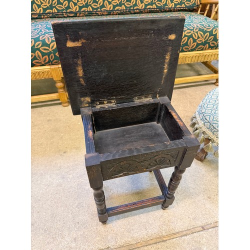 470 - A small carved oak stool/ side table with hinged top.