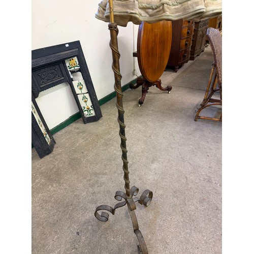 458 - An antique cast iron standard lamp with adjustable height section with shade.