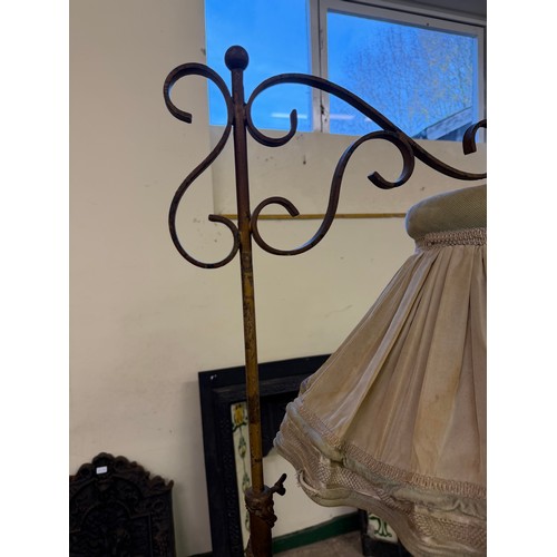 458 - An antique cast iron standard lamp with adjustable height section with shade.