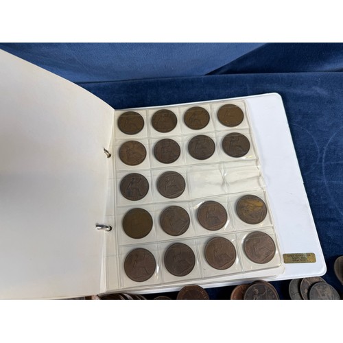 123 - An album containing a quantity of one penny and half penny coins, together with a large quantity of ... 
