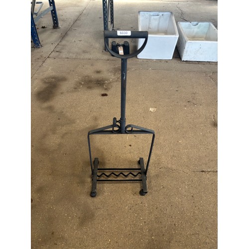 6030 - A wrought iron boot scrapper with adjustable handle.