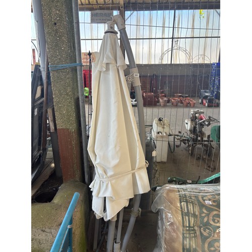 6061 - A white parasol with base.