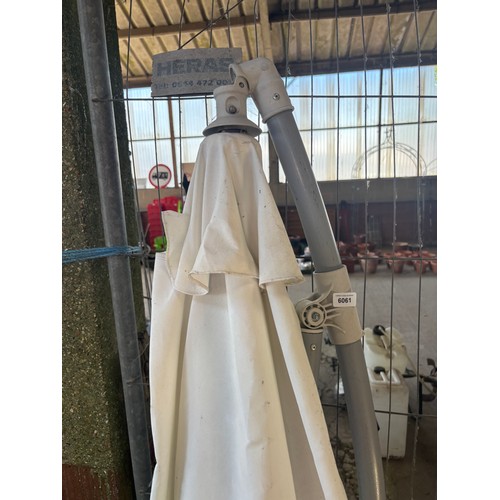 6061 - A white parasol with base.