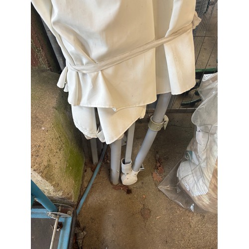 6061 - A white parasol with base.