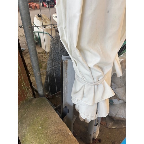 6061 - A white parasol with base.