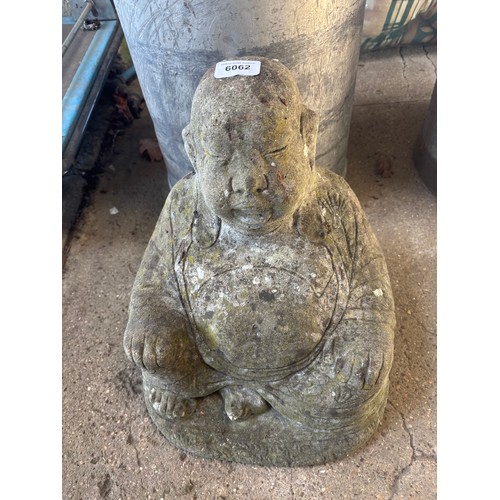 6062 - A concrete garden ornament of a Buddha.