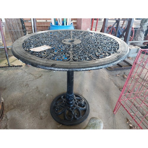 6248 - A black painted cast alloy garden bistro table, measuring 64cm high and 69cm diameter.