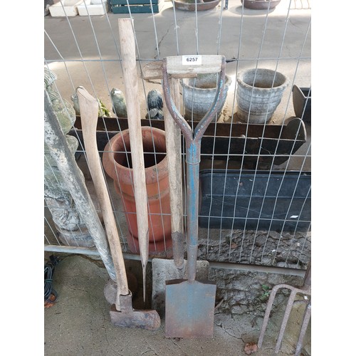6257 - Five garden tools including a shovel, spade, axe, slasher and an earth rammer.