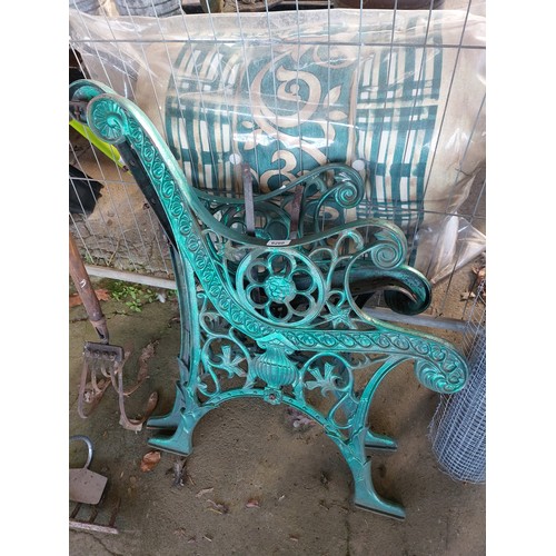 6260 - A pair of green painted cast iron bench ends with lion design.
