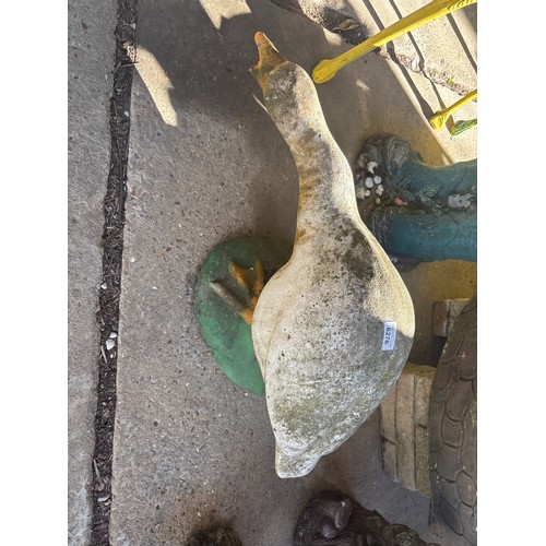 6276 - A concrete garden ornament of a goose.