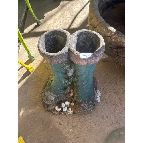 6277 - A concrete planter in the shape of Wellington boots.