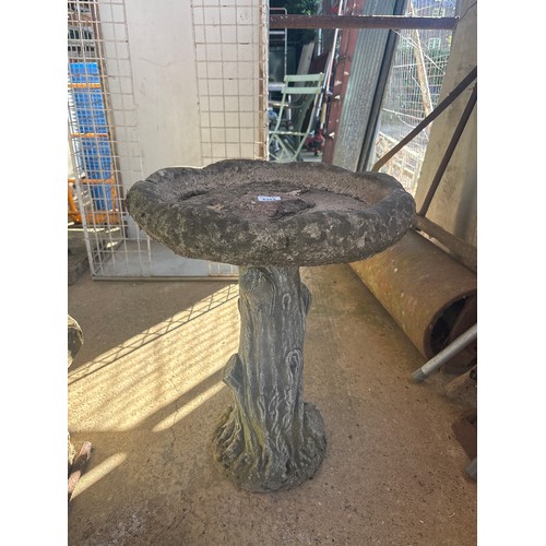 6281 - A concrete tree effect bird bath, measuring 57cm high.