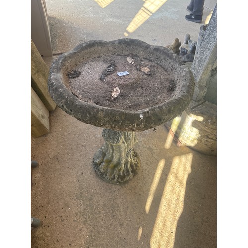 6281 - A concrete tree effect bird bath, measuring 57cm high.
