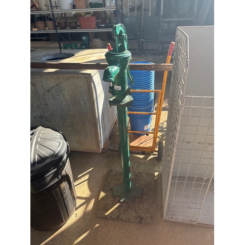 6284 - A cast iron water pump on concrete base, measuring 130cm high.