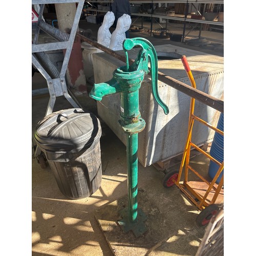 6284 - A cast iron water pump on concrete base, measuring 130cm high.