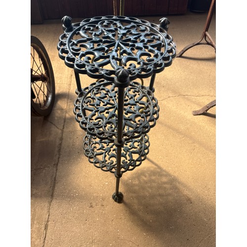 6377 - A cast iron 3-tier plant pot stand.