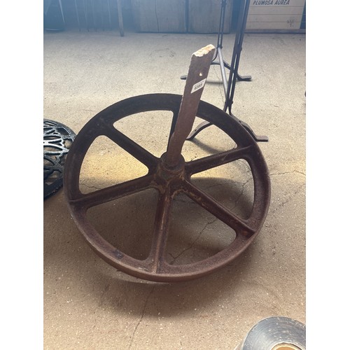 6385 - A cast iron wheel, measuring 64cm diameter.