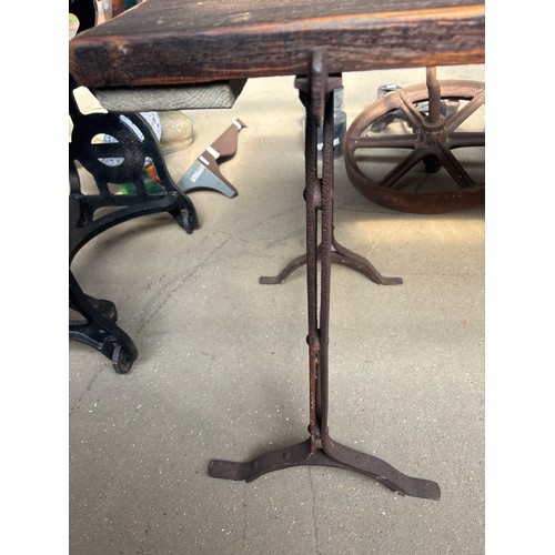 6386 - A vintage trestle table on vintage cast iron trestles. The top measures 182cm long x 72cm wide. The ... 