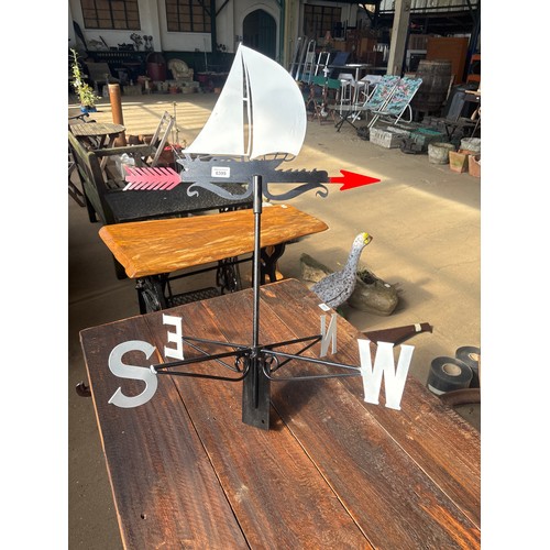 6399 - A metal weather vane with ship top.