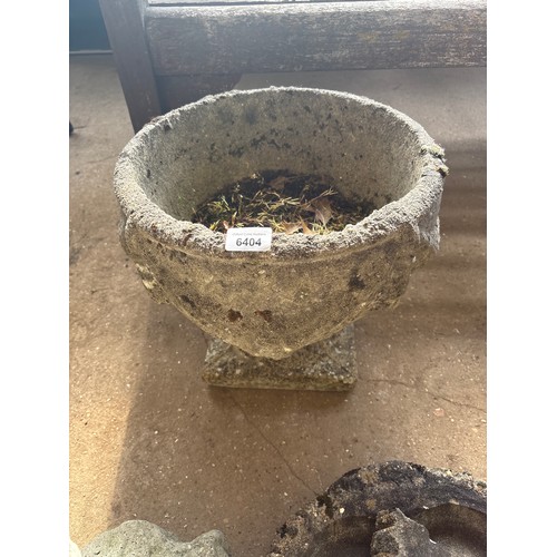 6404 - A concrete planter, measuring 32cm tall and 36cm diameter.