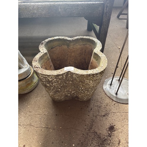 6407 - A shaped concrete garden pot, measuring 26cm tall and 33cm diameter.