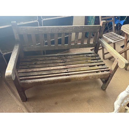 6409 - A teak wooden garden bench, measuring 130cm wide, 68cm deep and back measures 82cm tall.