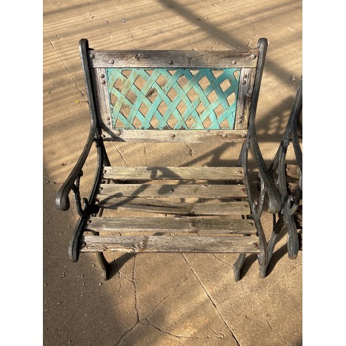 6417 - Two cast iron garden chairs with wooden slats.