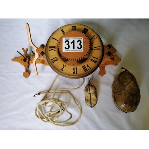 313 - A box containing a wooden clock mechanism, clock face etc