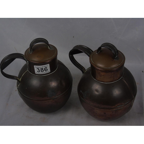 347 - Two copper Guernsey jugs, height 21cm
