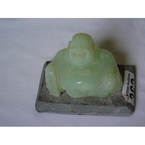362 - A green jade Buddha on slate base