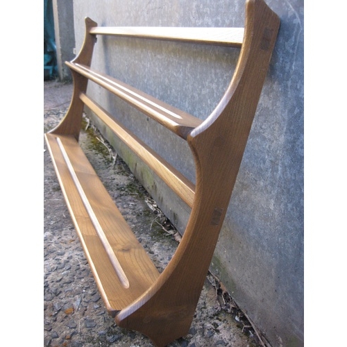 286 - An Ercol (stamped) mid century light wood plate rack with original wall fixings, elegant stag's horn... 