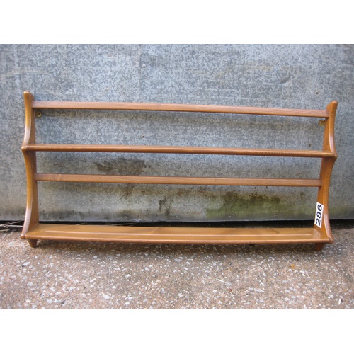286 - An Ercol (stamped) mid century light wood plate rack with original wall fixings, elegant stag's horn... 