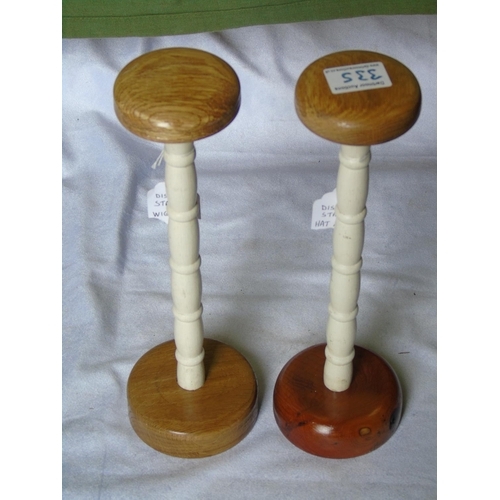 335 - A pair of wig/hat stands