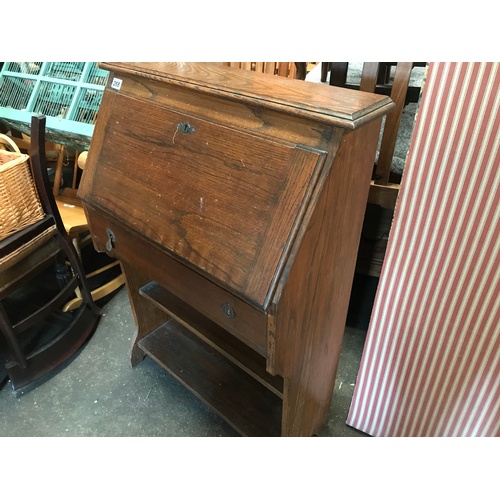268 - An early 20C oak fall front student's desk with stationery compartments as photographed, f/w drawer ... 