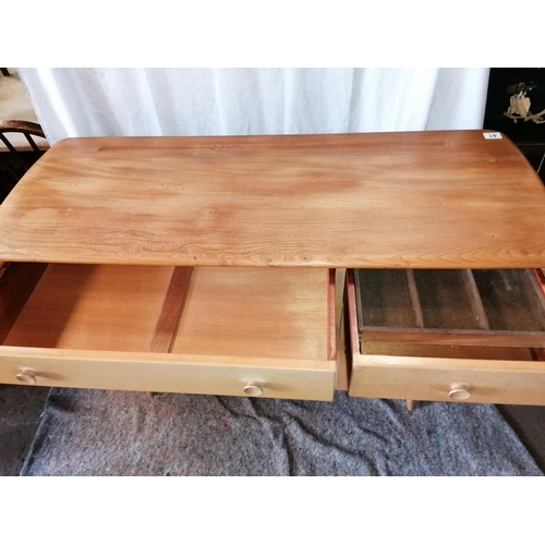 41 - A mid century Ercol Windsor blonde wood beech and elm sideboard in excellent condition, with cutlery... 