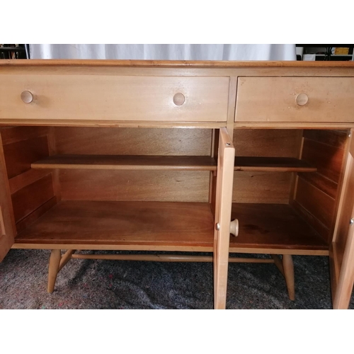 41 - A mid century Ercol Windsor blonde wood beech and elm sideboard in excellent condition, with cutlery... 